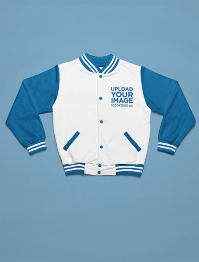Mockup of a Bomber Jacket Lying on a Colorful Surface