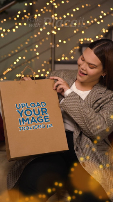 Video of a Surprised Smiling Woman Opening a Gift Bag for Christmas