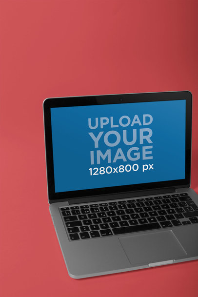 MacBook Mockup on a Solid Color Surface with an Angled Shot