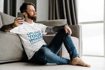 Round-Neck T-Shirt Mockup Featuring a Bearded Man Holding a Smartphone
