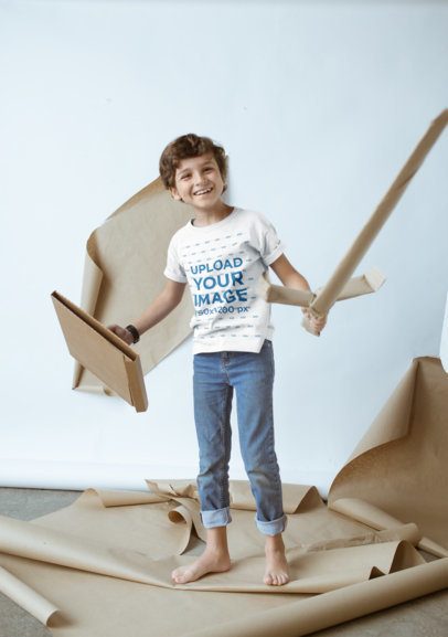 Happy Kid Wearing a T-Shirt Mockup Playing with Cardboard Toys