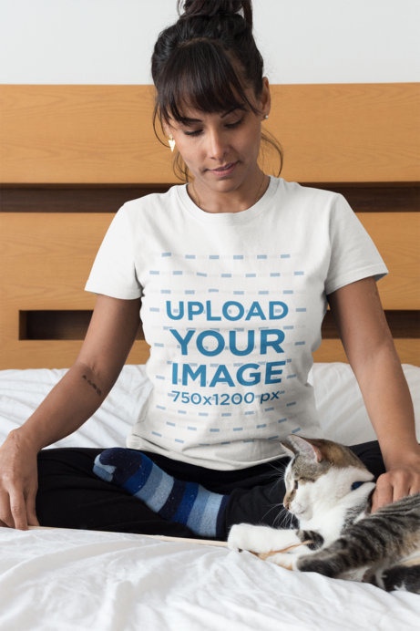 Woman Wearing a T-Shirt Mockup Petting her Cat on Bed