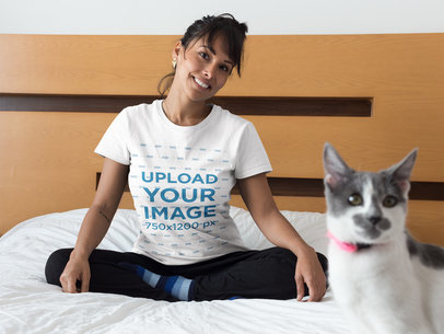 Happy Woman Wearing a T-Shirt Mockup on Bed with her Cat