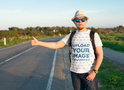 T-Shirt Mockup Featuring a Traveler Man Waiting for a Ride on the Road