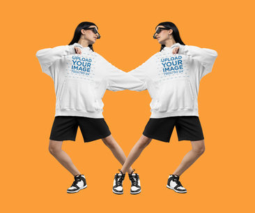 Mockup of a Woman in a Pullover Hoodie Posing at a Studio