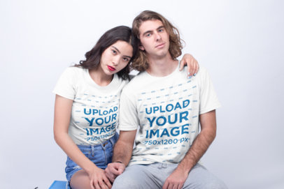 Interracial Couple of an Asian Girl and Blonde Man Wearing T-Shirts Mockup Holding Hands a19959