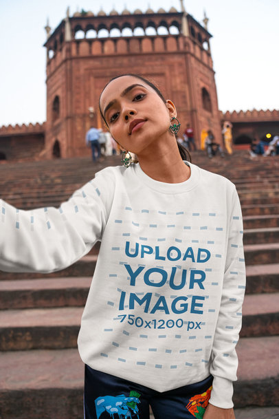Crewneck Sweatshirt Mockup Featuring a Woman Taking a Selfie With a Serious Look