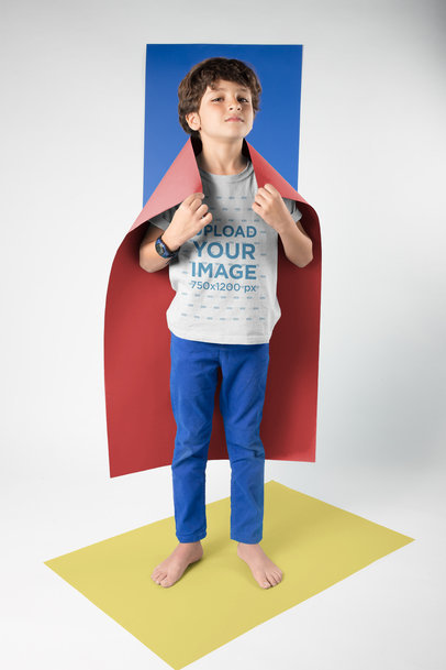 Kid Wearing a T-Shirt Mockup Using a Cape Standing on a Rectangle