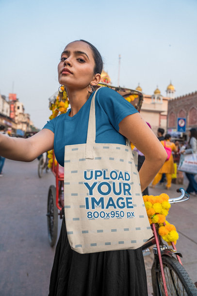 Tote Bag Mockup Featuring a Woman Posing in a Street
