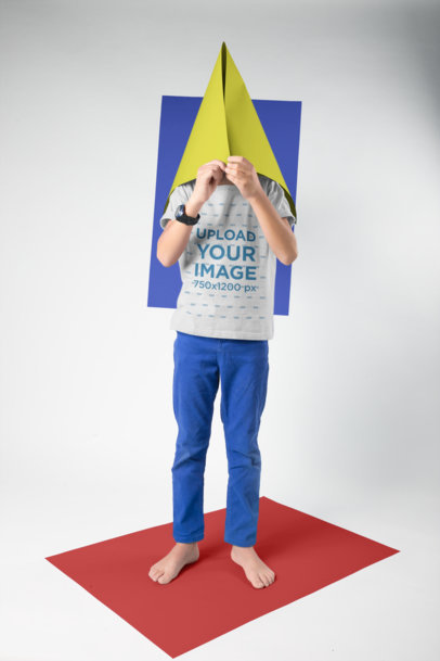 Kid Wearing a T-Shirt Mockup Hiding his Face in a Cone