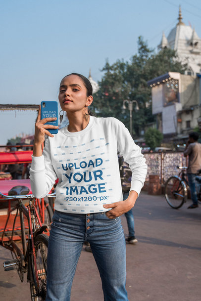 Selfie-Themed Mockup of a Woman Wearing a Sweatshirt and Holding a Phone
