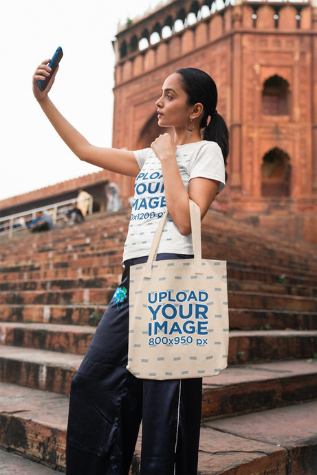 Gildan T-Shirt Mockup Featuring a Woman Carrying a Tote Bag