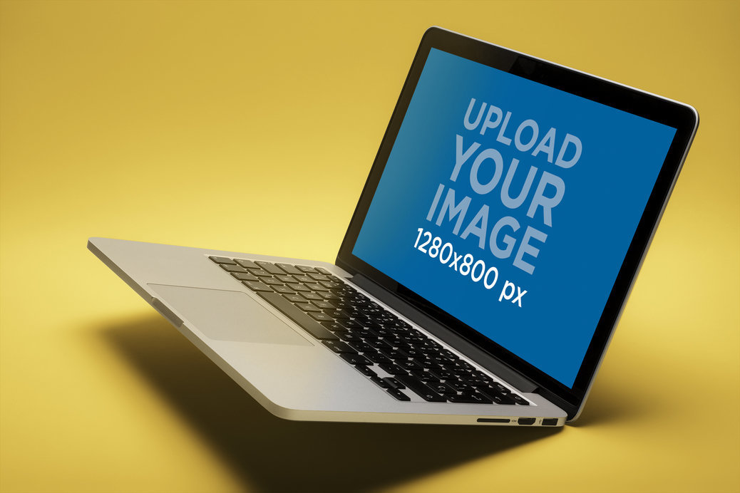 Mockup Featuring an Angled MacBook Pro Mockup Balancing Over a Solid Surface