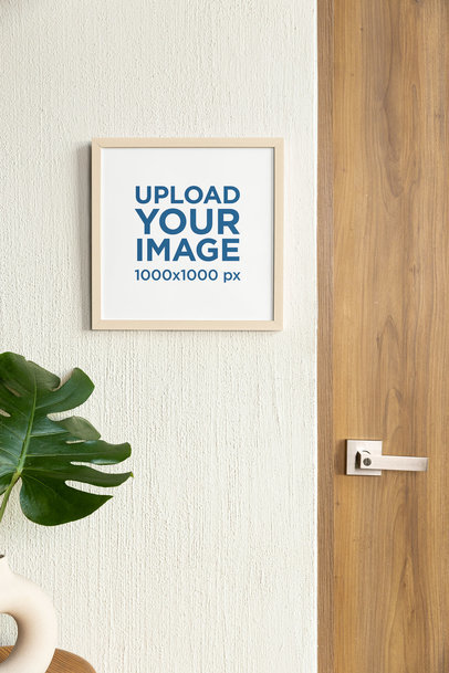 Mockup of a Squared Photo Frame Hanging on a Wall