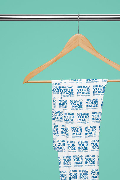 Mockup of a Pair of Sublimated Leggings Placed on a Hanger Featuring a Customizable Background