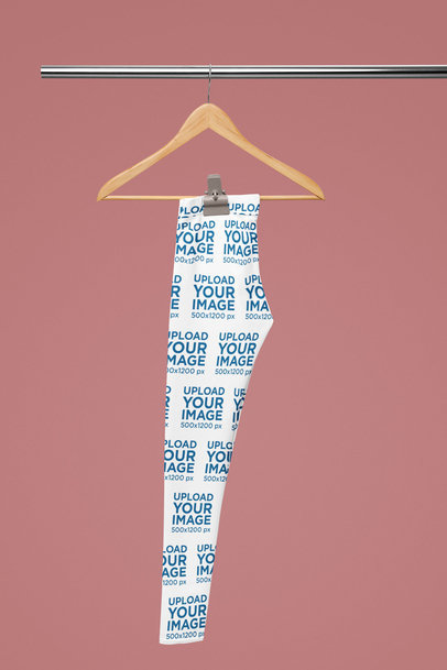 Mockup of a Pair of Leggings Placed on a Hanger Featuring a Colorful Background