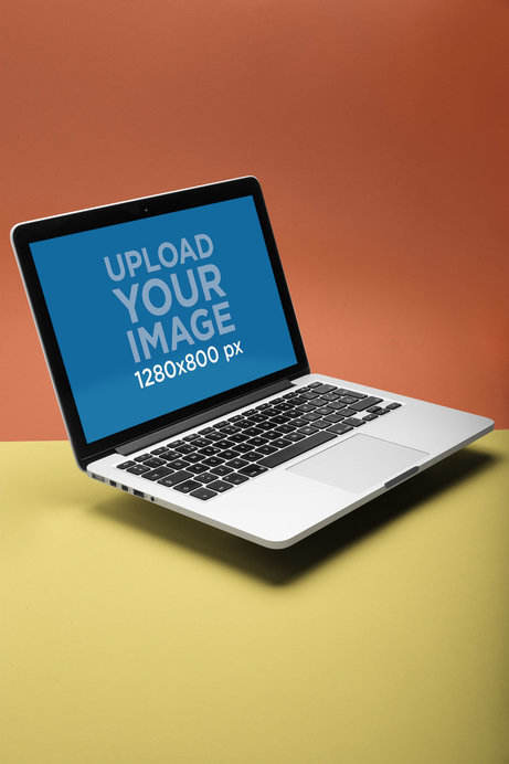 Mockup of a MacBook Floating on a Surface with Two Colors