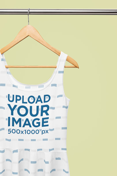 Mockup of a Sublimated Skater Dress Placed on a Wooden Hanger