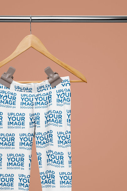 Mockup of a Pair of Leggings Placed on a Wooden Hanger