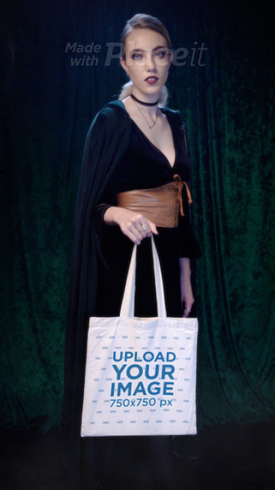 Video of a Woman in a Wicca Outfit Holding a Sublimated Tote Bag