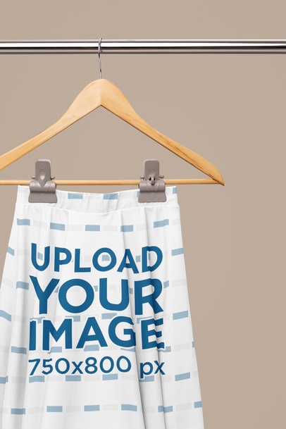 Mockup of a Sublimated Skater Skirt Placed on a Hanger Featuring a Customizable Background m31107