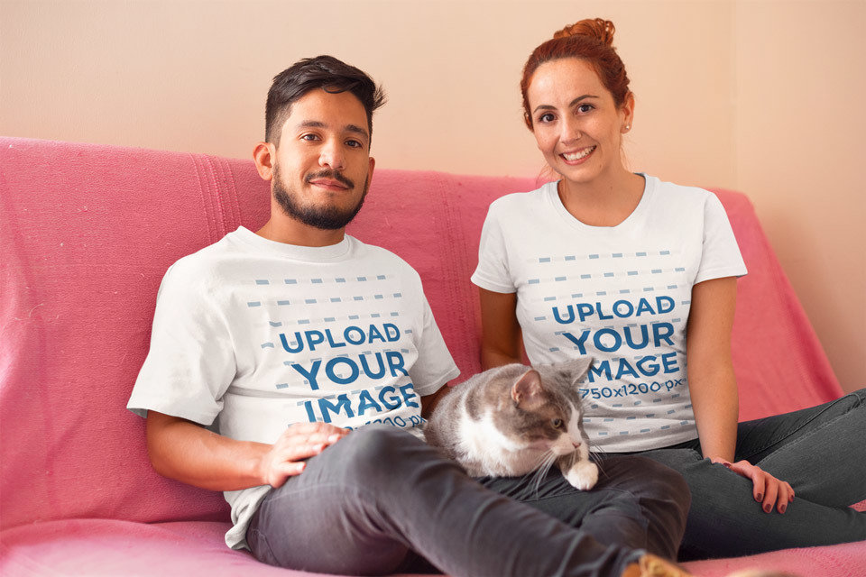 Happy Couple Wearing T-Shirts Mockup with Their Cat