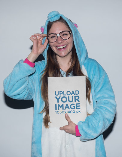 Happy Woman Holding a Book Mockup Dressed as an Unicorn