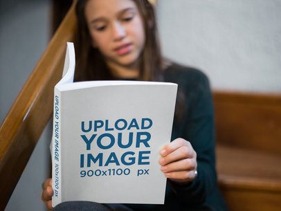 Book Mockup Being Read by a Girl Sitting on Stairs