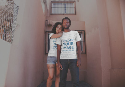 Young Couple Wearing T-Shirts Mockup Outside Their Apartment a20099