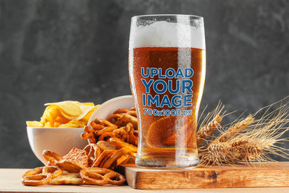 Mockup of a Beer Glass Placed Next to Oktoberfest Snacks