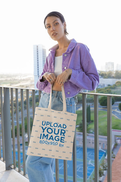 Mockup of a Serious Woman Carrying a Tote Bag While Posing for a TikTok