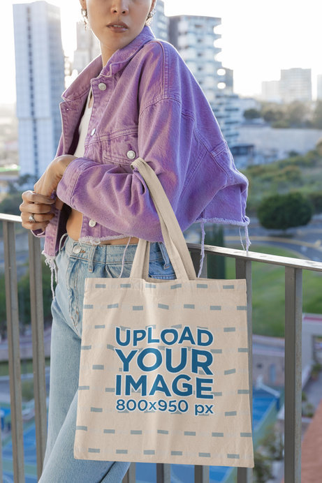Tote Bag Mockup Featuring a Cropped-Face Woman Posing for a TikTok