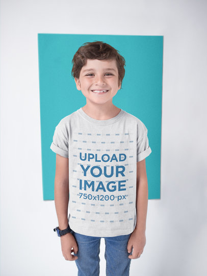 Happy White Kid Wearing a T-Shirt Mockup Against a Color Rectangle
