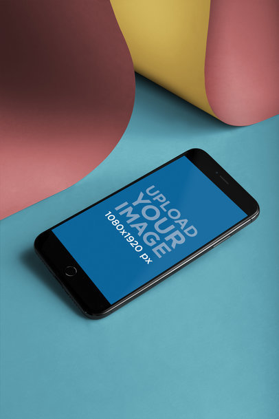 Mockup of an iPhone 8 Lying Over a Big Piece of Bent Paper a20464