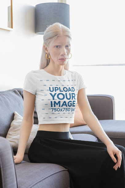Bella Canvas Crop Top Mockup Featuring a Serious Woman Sitting on a Couch m31717