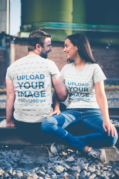 Happy Couple Wearing T-Shirts Template While Sitting on a Railway a20612