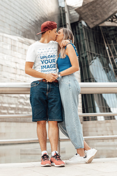 Round-Neck Tee Mockup of a Man Kissing His Girlfriend by a Building