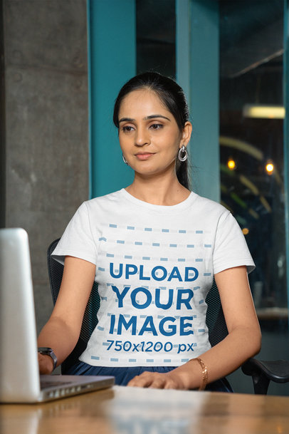 Gildan Tee Mockup of a Smiling Woman Working on a Laptop