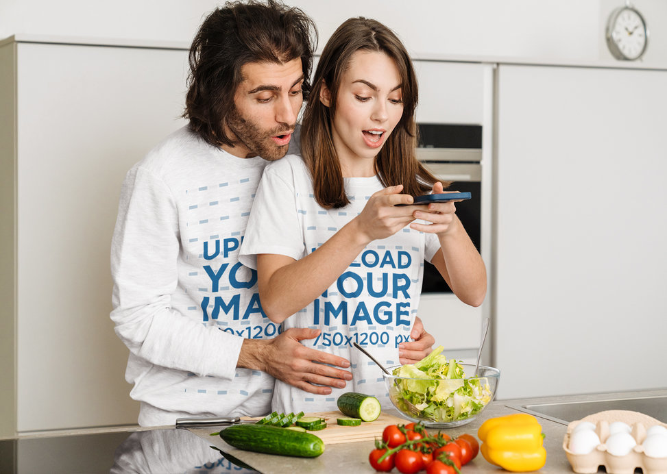 Sweatshirt and T-Shirt Mockup Featuring a Happy Couple Making a Salad Bowl