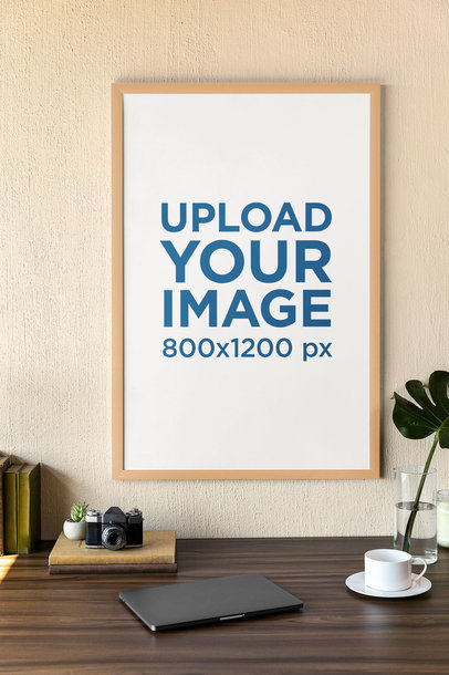 Mockup of an Art Print Frame Hanging on a Wall Featuring a Vintage Camera m31563