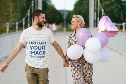 T-Shirt Mockup of a Smiling Man Holding Hands with His Girlfriend