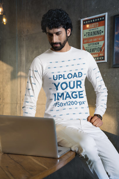 Bella Canvas Long-Sleeve Tee Mockup Featuring a Man Working on a Laptop m31759