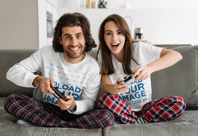 Sweatshirt and T-Shirt Mockup of a Happy Couple on a Couch with Gaming Controllers