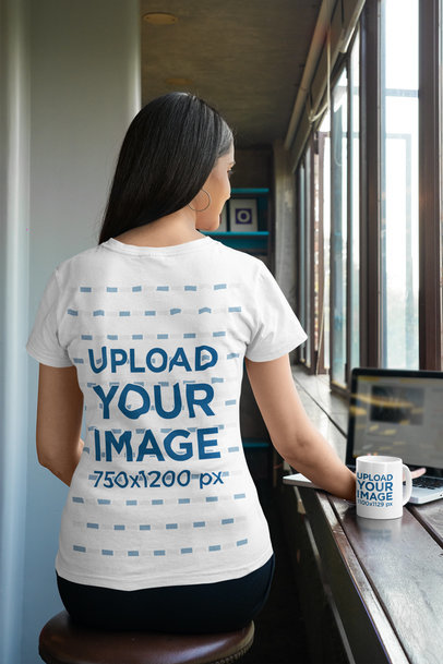 Coffee Mug Mockup of a Woman in a Gildan Tee Working on Her Laptop