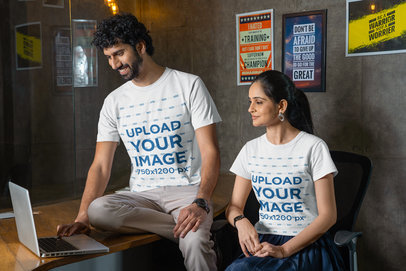 Gildan T-Shirt Mockup of a Two Coworkers Using a Laptop at an Office m31763