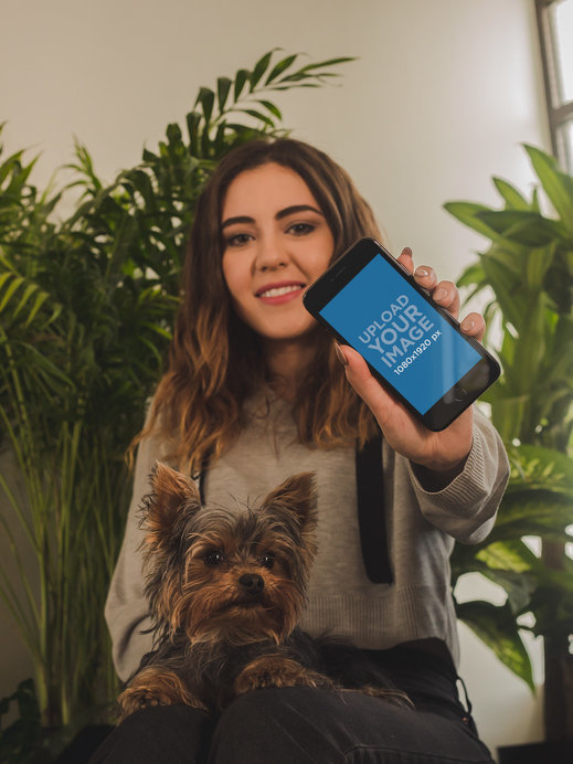 Woman Showing an App on her iPhone 8 Mockup while with her Dog