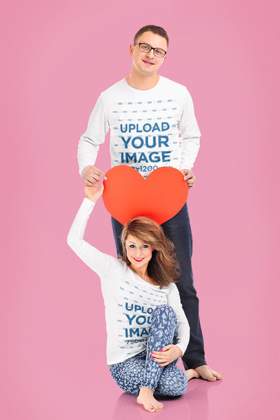 Valentine's Day Mockup Featuring a Couple Wearing Long Sleeve Tees While Holding a Paper Heart m31795 r-el2