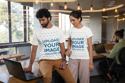 Round-Neck Tee Mockup of a Man and a Woman Working Together at an Office