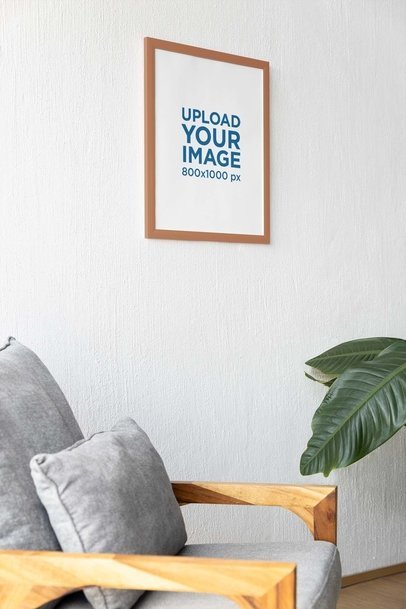 Mockup of an Art Print Hanging on a Wall Featuring a Couch m31575