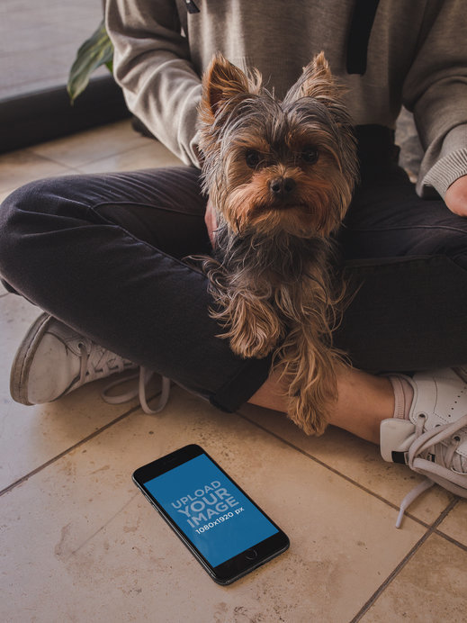 Space Gray iPhone Mockup Lying Near a Woman with her Dog